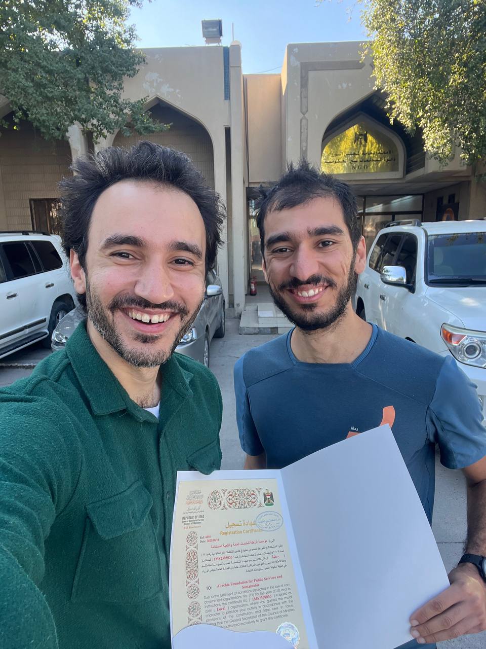 Mujtaba and Murtadha holding the certificate of registration for the NGO Journey