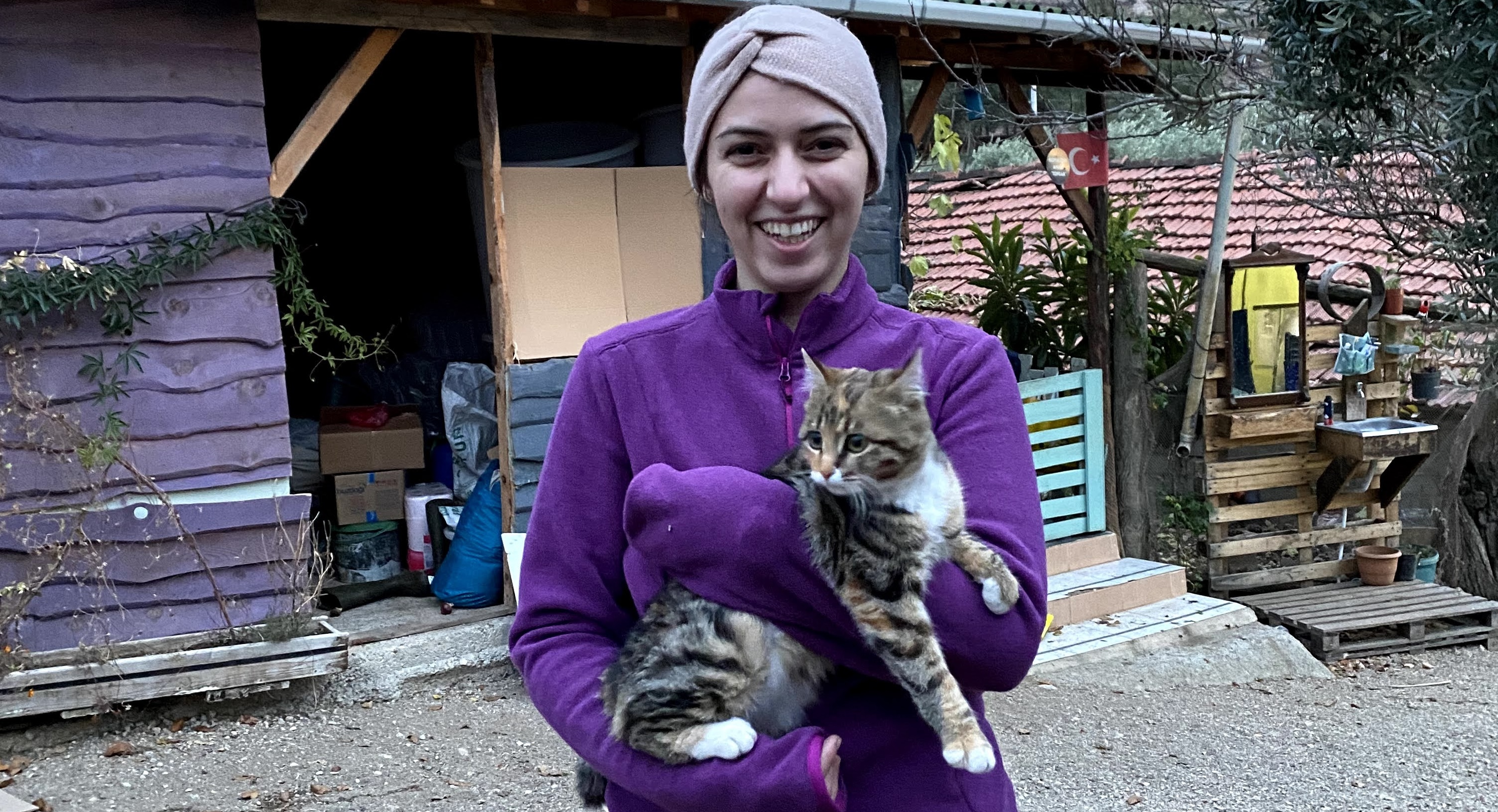 Mina carrying Bazooni at a farm