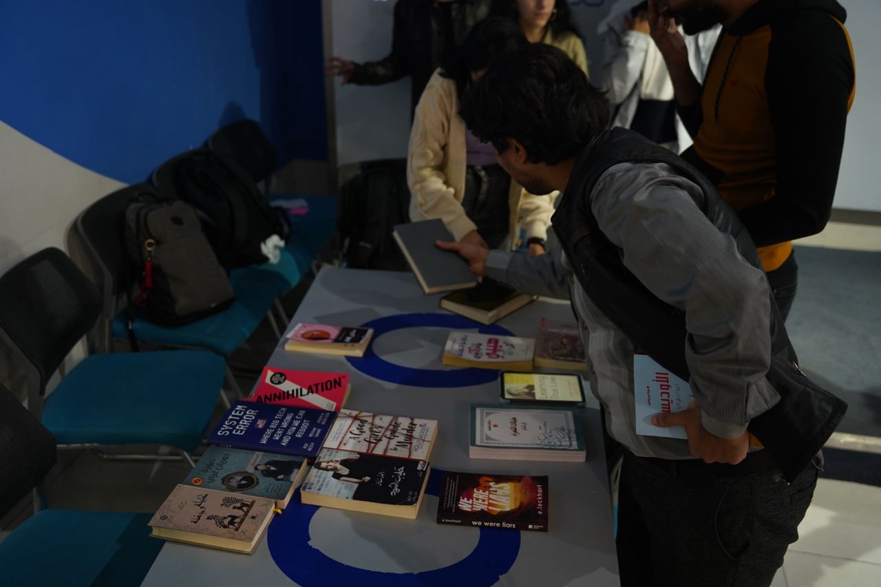 People picking out books from a table